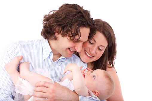 Infant using a 3-in-1 teething mitten, enjoying gum relief with a soft, chewable surface and engaging crinkle sound.